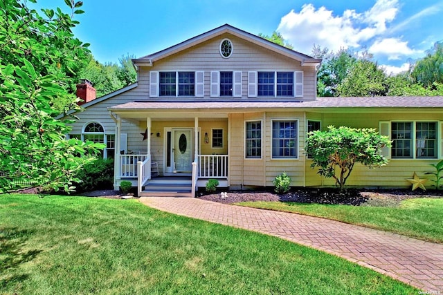 150 N Woods Dr, Wading River, NY 11792 - traditional-style house with a porch and a front yard