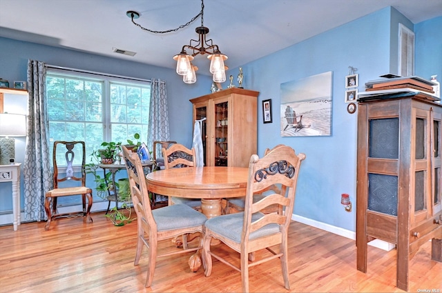 150 N Woods Dr, Wading River, NY 11792 - dining space featuring visible vents, baseboards, light wood finished floors, and a notable chandelier