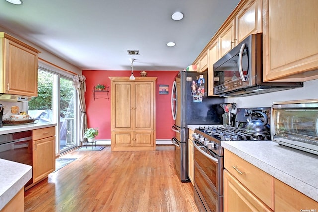 150 N Woods Dr, Wading River, NY 11792 - kitchen featuring light brown cabinets, visible vents, light countertops, and double oven range