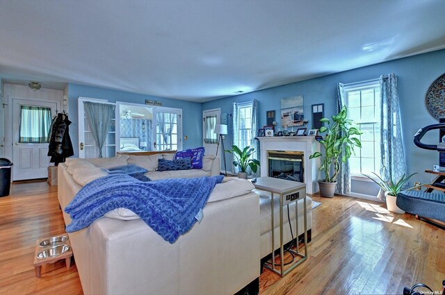 150 N Woods Dr, Wading River, NY 11792 - living area with a glass covered fireplace and wood finished floors
