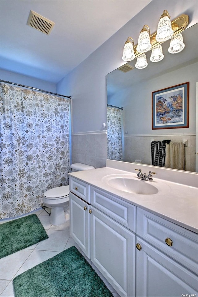 150 N Woods Dr, Wading River, NY 11792 - bathroom featuring vanity, visible vents, a wainscoted wall, toilet, and tile patterned floors