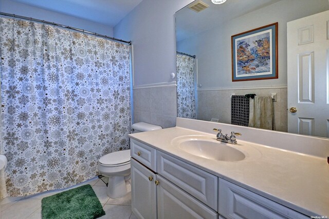 150 N Woods Dr, Wading River, NY 11792 - full bathroom featuring vanity, tile patterned flooring, visible vents, a wainscoted wall, and toilet