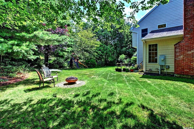 150 N Woods Dr, Wading River, NY 11792 - view of yard with a fire pit and a playground