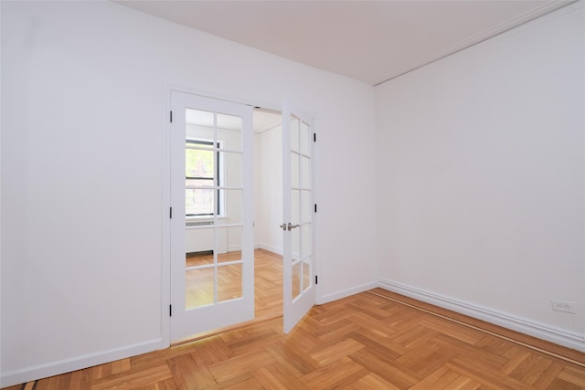 spare room with french doors and baseboards