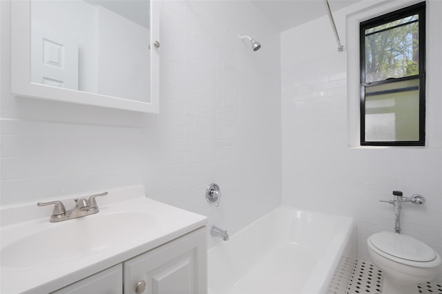 bathroom featuring toilet, tile walls, tile patterned floors, shower / washtub combination, and vanity