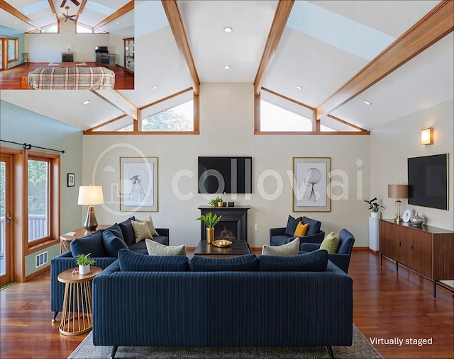 living area featuring wood finished floors, vaulted ceiling with beams, a fireplace, baseboards, and visible vents