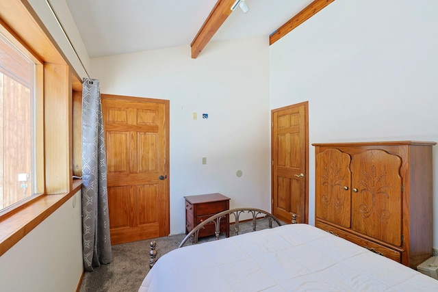 carpeted bedroom with beamed ceiling