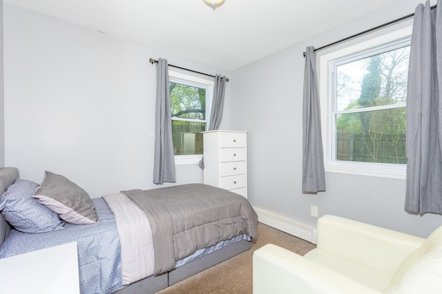 carpeted bedroom with a baseboard heating unit