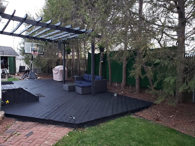 deck featuring fence and a pergola