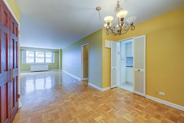 102-30 66th Rd Unit 5A, Forest Hills, NY 11375 - unfurnished room with a chandelier, baseboards, and radiator heating unit