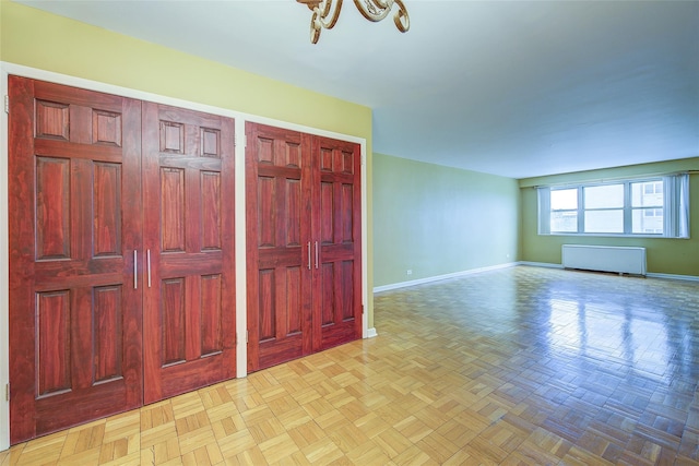 102-30 66th Rd Unit 5A, Forest Hills, NY 11375 - spare room with baseboards and radiator heating unit