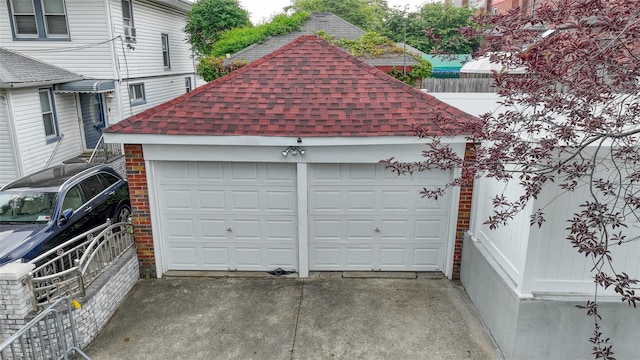191-68 115th Rd, Saint Albans, NY 11412 - garage featuring concrete driveway and fence