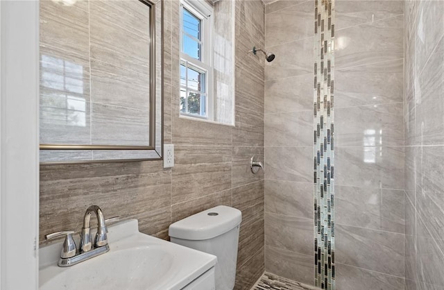 191-68 115th Rd, Saint Albans, NY 11412 - bathroom featuring tiled shower, a sink, toilet, and tile walls