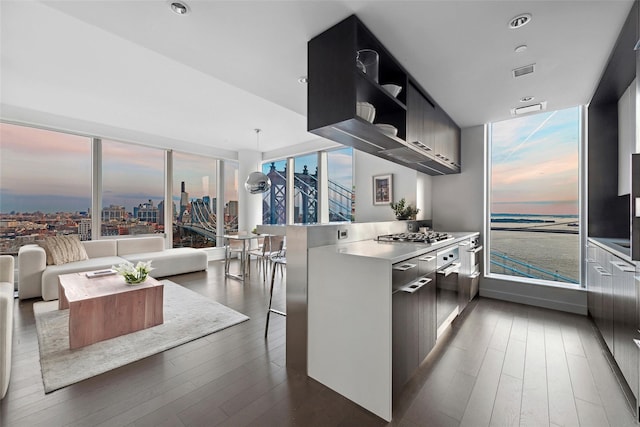 kitchen with open shelves, visible vents, dark wood-style flooring, modern cabinets, and a peninsula