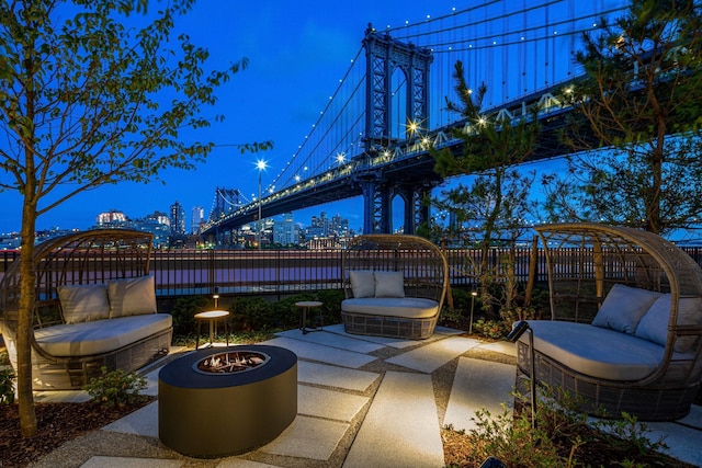 view of patio featuring fence and a city view