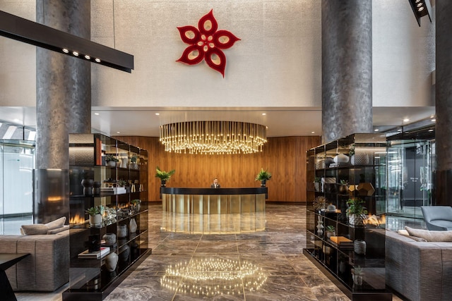welcome area with decorative columns and a chandelier