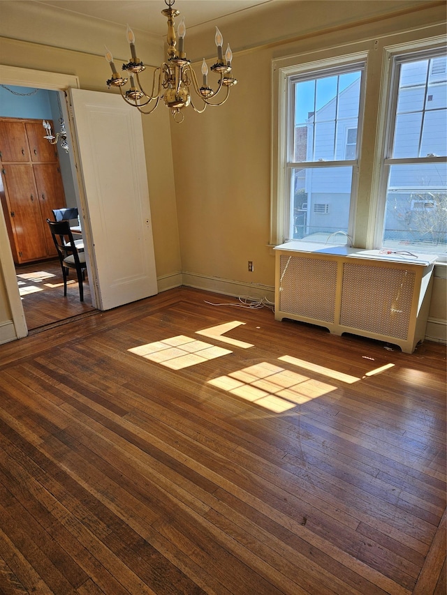 182 Parkway N, Yonkers, NY 10704 - unfurnished dining area with wood-type flooring, radiator heating unit, baseboards, and a notable chandelier