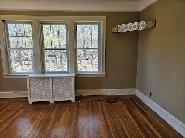 182 Parkway N, Yonkers, NY 10704 - interior space featuring radiator heating unit, a wealth of natural light, baseboards, and hardwood / wood-style floors