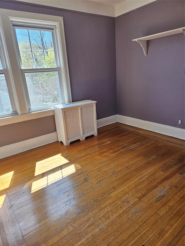 182 Parkway N, Yonkers, NY 10704 - empty room with radiator, hardwood / wood-style flooring, and baseboards