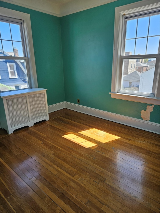 182 Parkway N, Yonkers, NY 10704 - empty room with crown molding, baseboards, radiator heating unit, and hardwood / wood-style floors