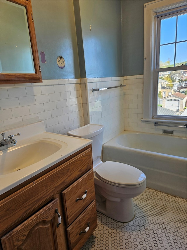 182 Parkway N, Yonkers, NY 10704 - bathroom with a wealth of natural light, toilet, tile patterned flooring, and tile walls