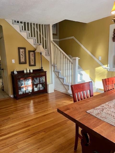 dining area featuring stairway and hardwood / wood-style flooring