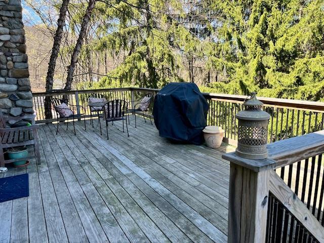 wooden deck featuring a grill