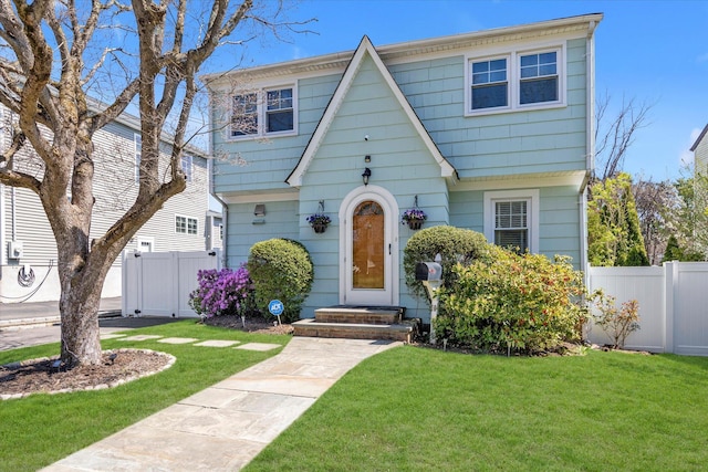 view of front of house with fence and a front yard