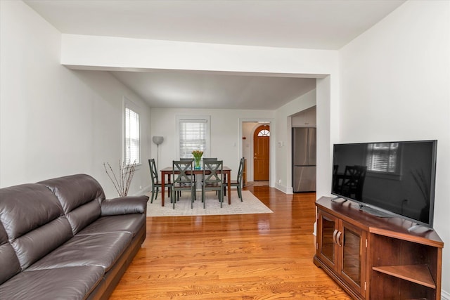 living area featuring baseboards and light wood-type flooring
