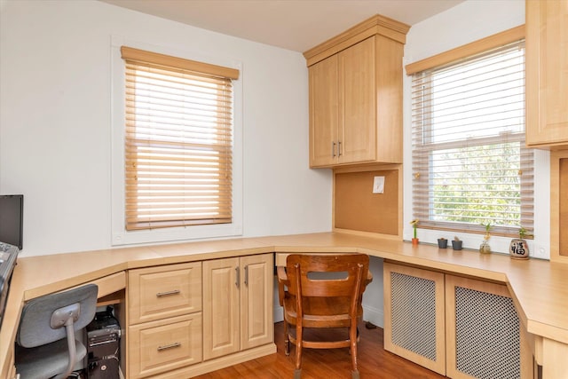 office area with built in desk and wood finished floors