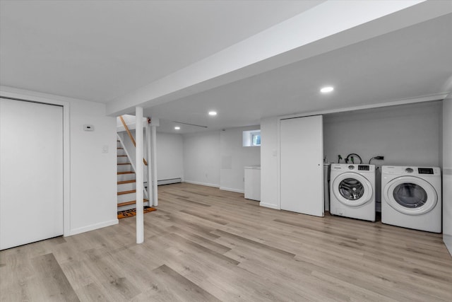 below grade area with light wood-style floors, recessed lighting, washing machine and dryer, and stairs