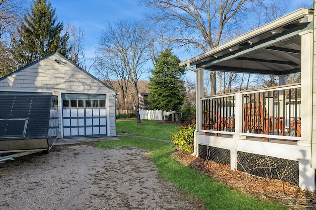 view of yard featuring an outdoor structure, a garage, and a deck