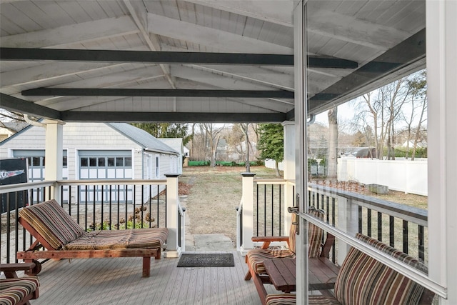 wooden terrace featuring an outbuilding