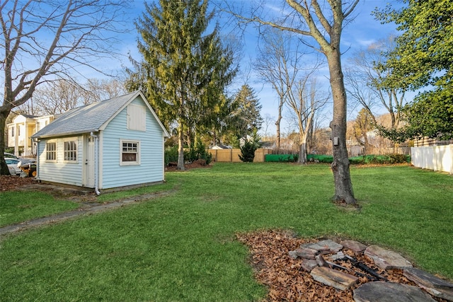 view of yard with fence and an outbuilding
