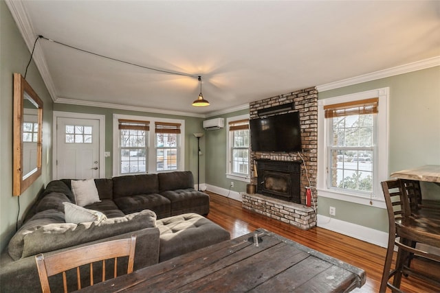 living room featuring wood finished floors, a brick fireplace, an AC wall unit, and baseboards