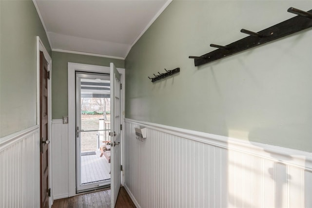 doorway to outside with a wainscoted wall, ornamental molding, and dark wood finished floors