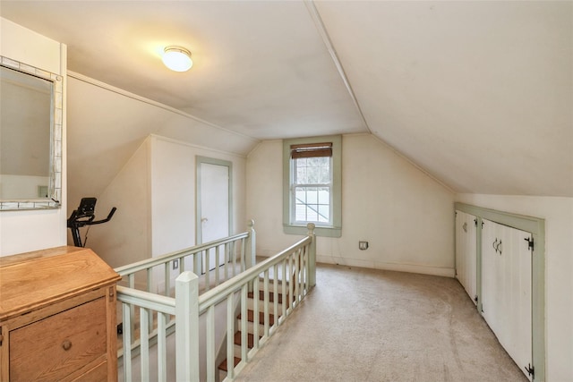 bonus room featuring lofted ceiling and light carpet