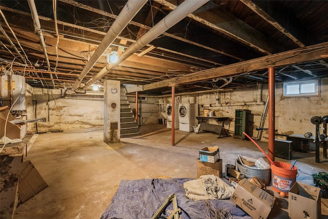 below grade area featuring washing machine and dryer and stairs