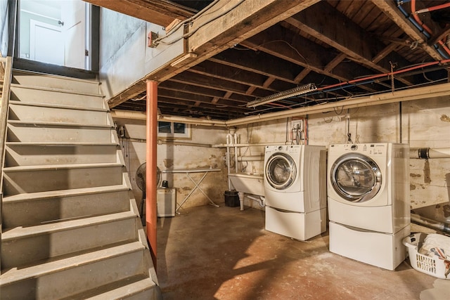 unfinished below grade area with washing machine and dryer, stairway, and a sink