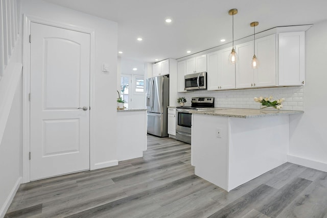 286 9th St, Verplanck, NY 10596 - kitchen featuring stainless steel appliances, light wood-style floors, a peninsula, white cabinetry, and recessed lighting