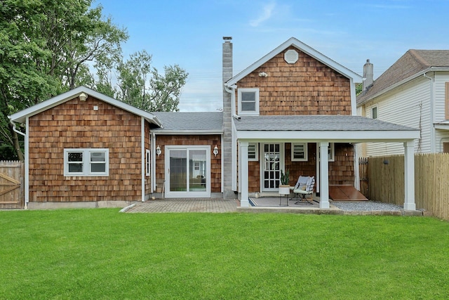 286 9th St, Verplanck, NY 10596 - rear view of property featuring a chimney, a patio, and a shingled roof