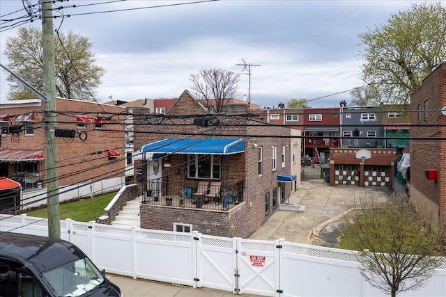 1021 E 213th St, Bronx, NY 10469 - exterior space featuring a gate, brick siding, a garage, and a fenced front yard