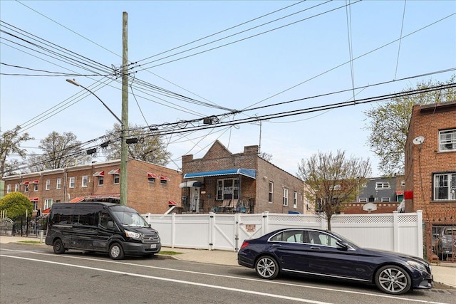 1021 E 213th St, Bronx, NY 10469 - view of front of home featuring fence and a gate