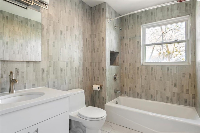 bathroom with tile patterned floors, vanity, tile walls, shower / bath combination, and toilet