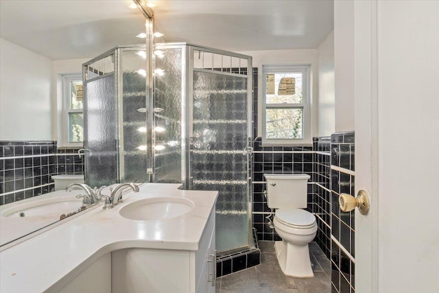 full bathroom featuring tile walls, a wealth of natural light, toilet, and tile patterned floors