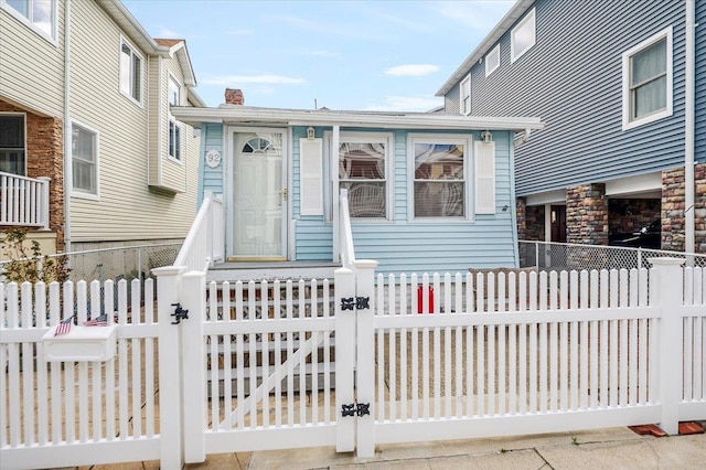 92 Nebraska St, Long Beach, NY 11561 - view of front of property featuring a gate, a chimney, and a fenced front yard