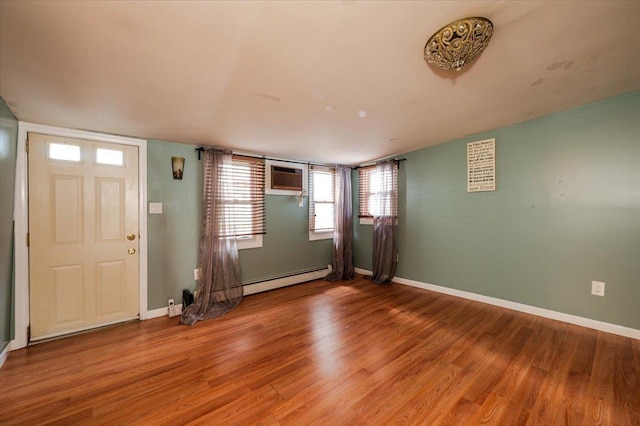 92 Nebraska St, Long Beach, NY 11561 - foyer entrance featuring baseboards, a wall mounted AC, light wood-style flooring, and baseboard heating