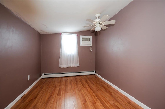 92 Nebraska St, Long Beach, NY 11561 - spare room with light wood finished floors, vaulted ceiling, a wall unit AC, baseboards, and a baseboard radiator