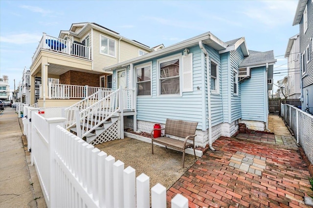 92 Nebraska St, Long Beach, NY 11561 - back of house with a fenced backyard and a balcony