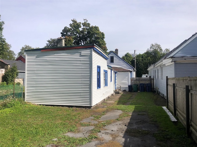 view of property exterior with fence